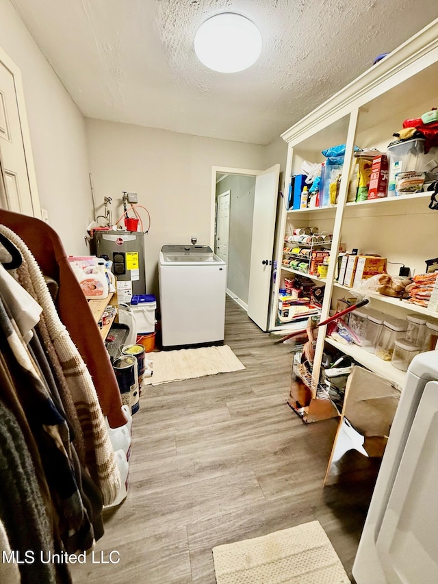 412 Monica Ln, Pearl, MS 39208 - clothes washing area with washer / dryer, water heater, wood finished floors, and a textured ceiling