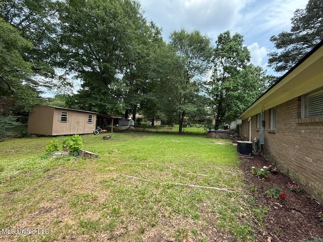 412 Monica Ln, Pearl, MS 39208 - view of green lawn with an outbuilding and cooling unit