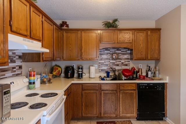 kitchen with white appliances, backsplash, a textured ceiling, and light tile patterned floors