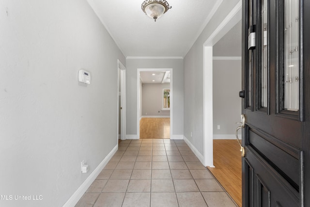 entrance foyer with crown molding and light hardwood / wood-style flooring