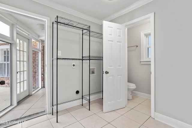 bathroom with tile patterned floors, toilet, and ornamental molding