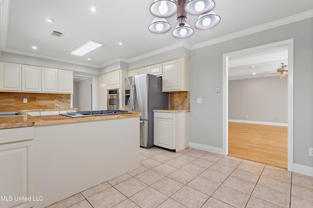 kitchen featuring white cabinets, light tile patterned flooring, stainless steel appliances, and tasteful backsplash