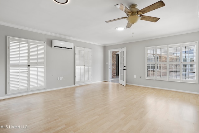 interior space featuring a wall mounted air conditioner, french doors, light hardwood / wood-style flooring, ceiling fan, and ornamental molding