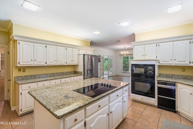 kitchen featuring white cabinets, a kitchen island, and black appliances