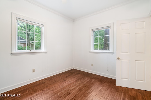 unfurnished room with hardwood / wood-style floors and crown molding