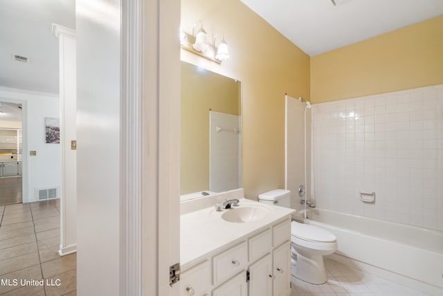 full bathroom with tile patterned flooring, tiled shower / bath combo, toilet, and vanity