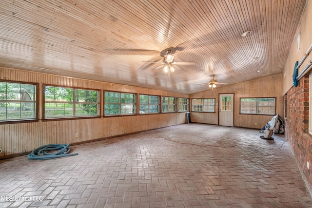 unfurnished sunroom with ceiling fan, plenty of natural light, wooden ceiling, and vaulted ceiling