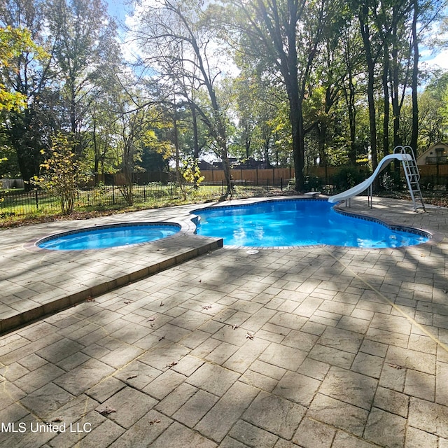 view of pool featuring a patio and a water slide