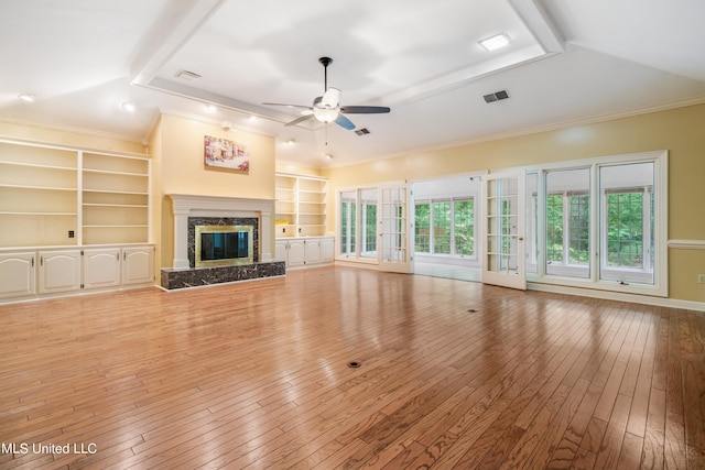 unfurnished living room featuring ceiling fan, a fireplace, wood-type flooring, and ornamental molding