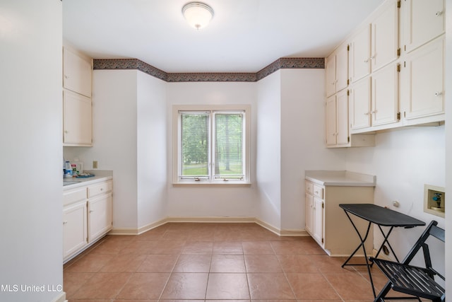 kitchen featuring white cabinetry and light tile patterned flooring