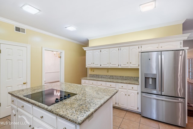 kitchen featuring stainless steel fridge, ornamental molding, black electric cooktop, a center island, and white cabinetry