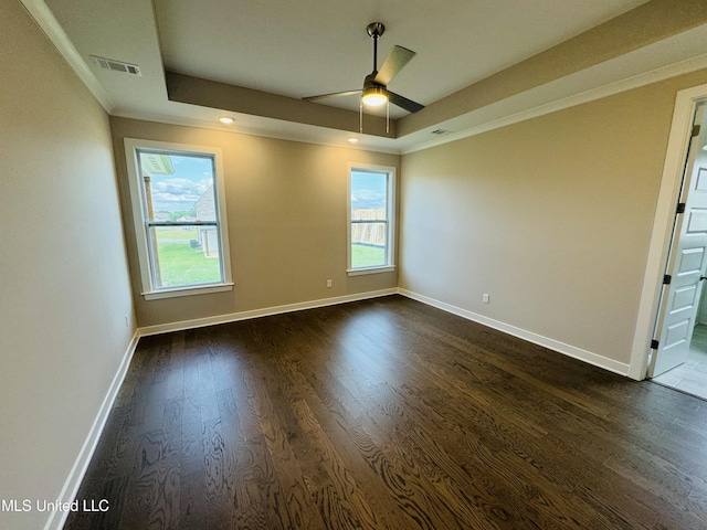 3919 Mcelroy Farms Dr, Olive Branch, MS 38654 - spare room with a tray ceiling, dark wood-type flooring, a ceiling fan, and ornamental molding