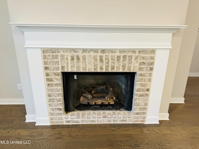 3919 Mcelroy Farms Dr, Olive Branch, MS 38654 - detailed view of a brick fireplace and wood finished floors