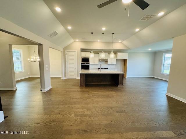3919 Mcelroy Farms Dr, Olive Branch, MS 38654 - kitchen featuring appliances with stainless steel finishes, white cabinetry, light countertops, an island with sink, and dark wood-style flooring