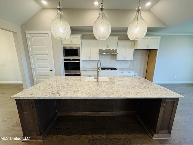 3919 Mcelroy Farms Dr, Olive Branch, MS 38654 - kitchen featuring under cabinet range hood, stainless steel appliances, vaulted ceiling, a large island, and white cabinetry