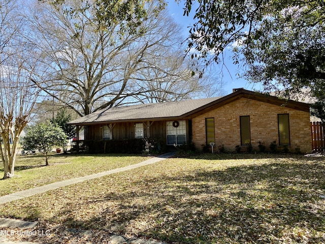 view of front of property with brick siding and a front lawn