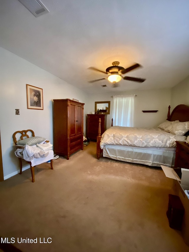 bedroom with visible vents, light carpet, and a ceiling fan