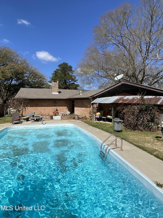 outdoor pool with a patio area