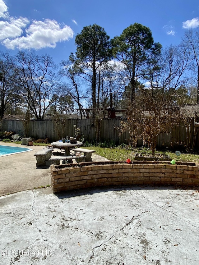 view of patio / terrace featuring a fenced backyard and a fenced in pool