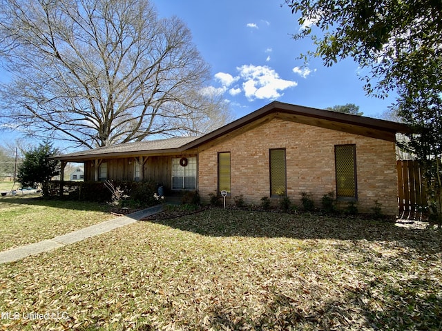 view of side of property featuring a yard