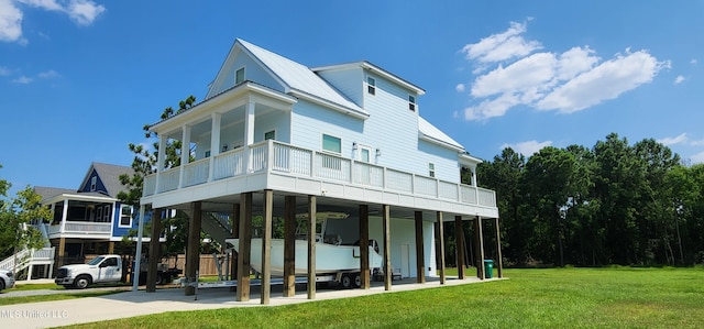 back of house featuring a lawn and a carport