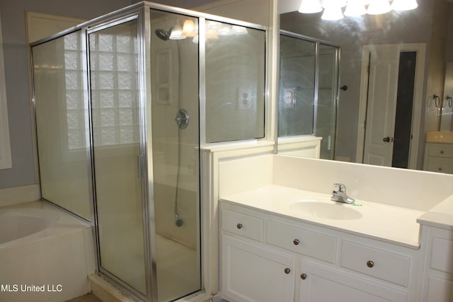 bathroom with vanity and independent shower and bath