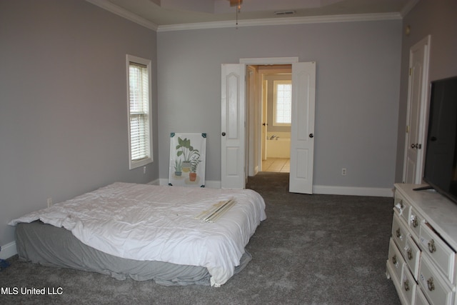 carpeted bedroom featuring connected bathroom and ornamental molding