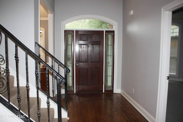 entrance foyer featuring ornamental molding and dark hardwood / wood-style flooring