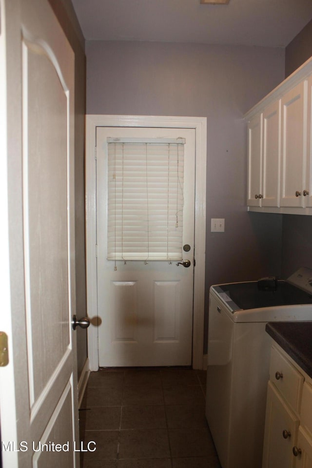 laundry room with cabinets and dark tile patterned flooring