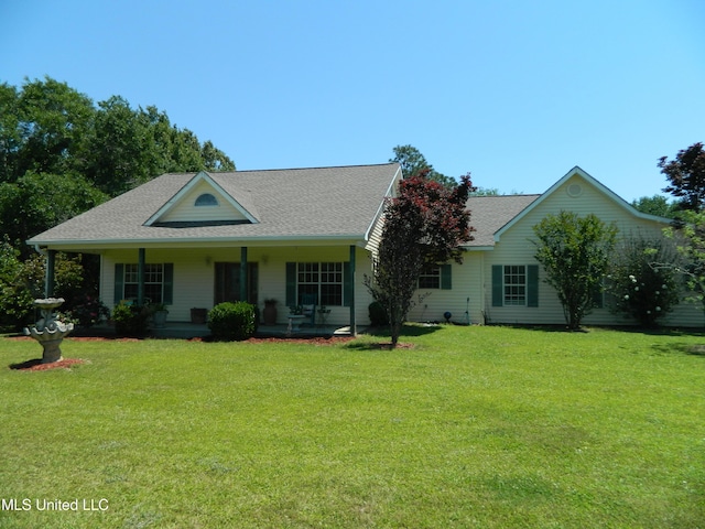 view of front of property featuring a shingled roof, covered porch, and a front yard