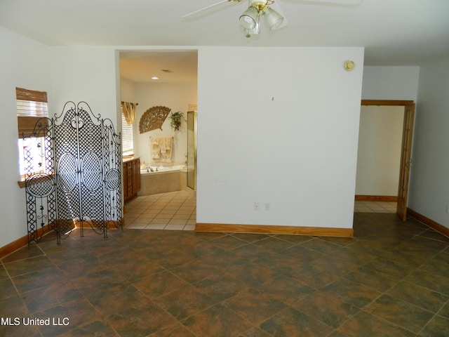 unfurnished room featuring ceiling fan, baseboards, and tile patterned flooring