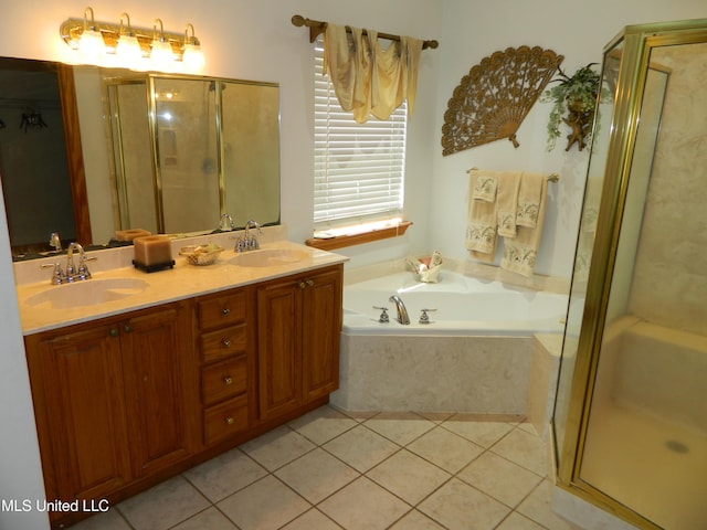 full bath with a bath, tile patterned floors, a sink, and a shower stall