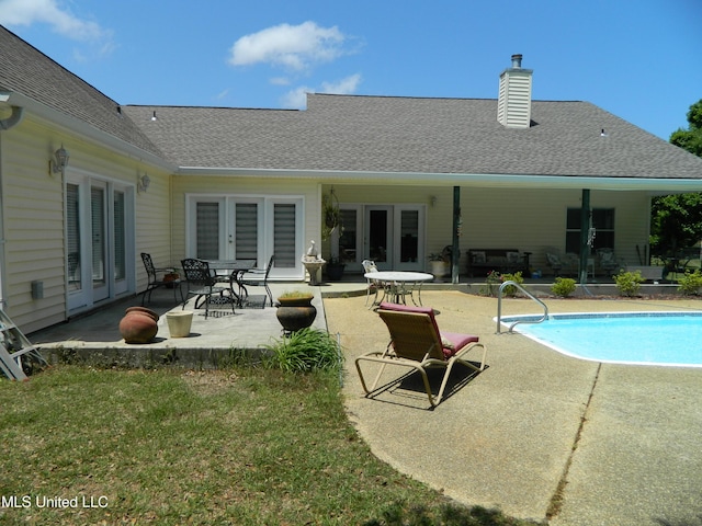 outdoor pool featuring a patio and french doors