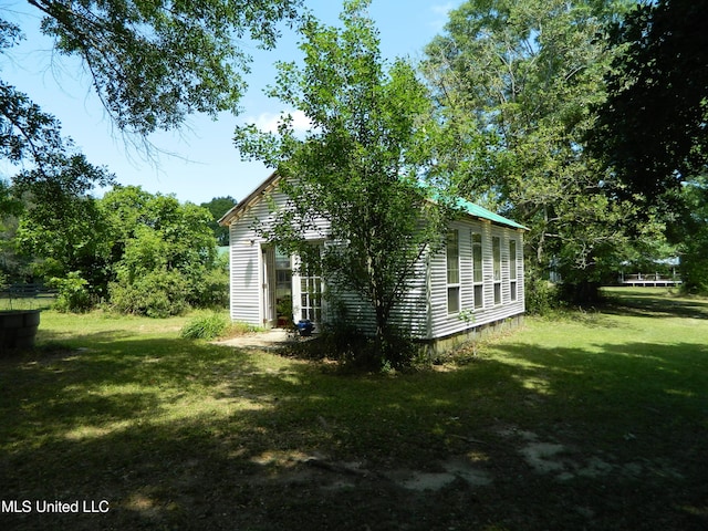 view of home's exterior with a yard