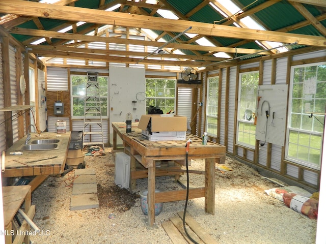 office area featuring lofted ceiling and a sink