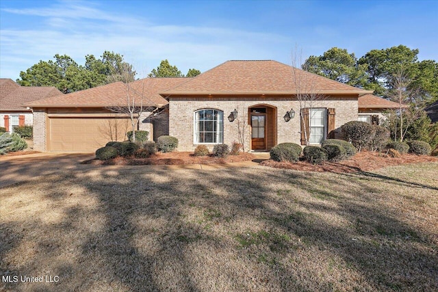 view of front of house featuring a garage and a front lawn