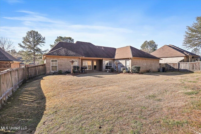 rear view of house featuring a lawn