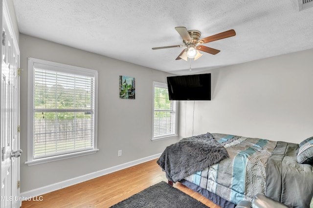 1201 Arbor Hill Dr, Brandon, MS 39042 - bedroom featuring wood finished floors, baseboards, a textured ceiling, and ceiling fan