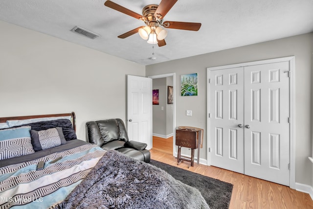 1201 Arbor Hill Dr, Brandon, MS 39042 - bedroom with light wood-style floors, a ceiling fan, baseboards, a closet, and a textured ceiling