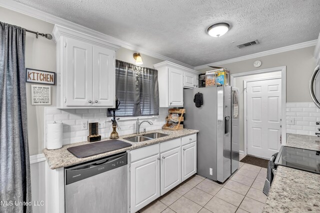 1201 Arbor Hill Dr, Brandon, MS 39042 - kitchen featuring stainless steel appliances, a sink, white cabinets, tasteful backsplash, and light tile patterned flooring