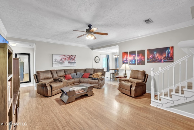 1201 Arbor Hill Dr, Brandon, MS 39042 - living room featuring wood finished floors, a ceiling fan, stairway, a chandelier, and a textured ceiling