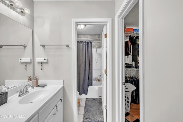 1201 Arbor Hill Dr, Brandon, MS 39042 - bathroom with vanity, a spacious closet, and shower / tub combo with curtain