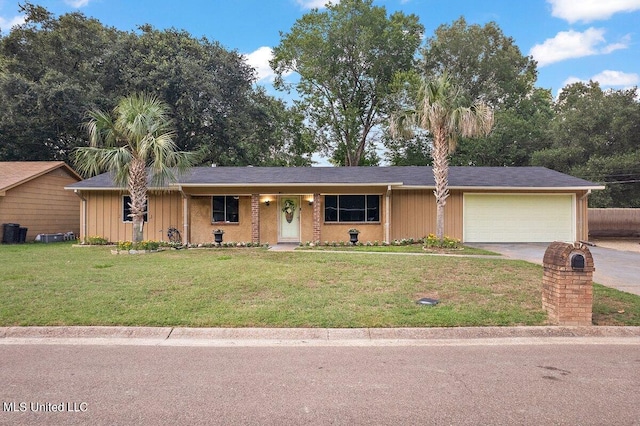 single story home featuring a garage and a front lawn