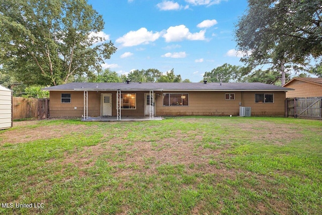 back of property with a patio, a lawn, and central AC unit