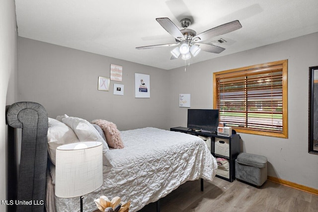 bedroom with light wood-type flooring and ceiling fan