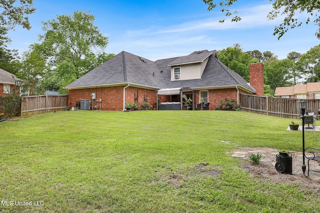 108 Kenbridge Ln, Madison, MS 39110 - rear view of property featuring brick siding, central AC unit, a shingled roof, and a hot tub