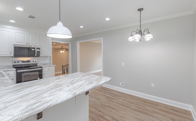 kitchen with tasteful backsplash, crown molding, stainless steel appliances, and white cabinets