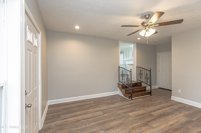 interior space featuring ceiling fan, a textured ceiling, and dark hardwood / wood-style flooring