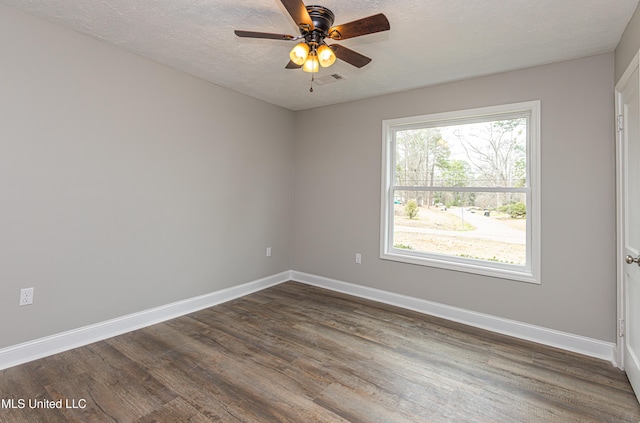 unfurnished room with ceiling fan, a textured ceiling, and dark hardwood / wood-style flooring