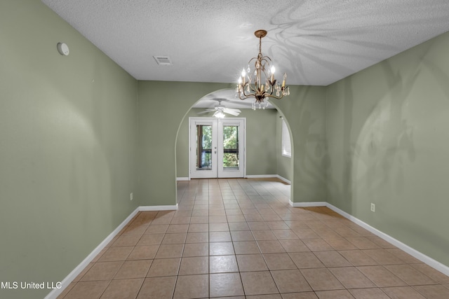 3005 Robalo Dr, Gautier, MS 39553 - unfurnished room featuring arched walkways, a textured ceiling, a chandelier, tile patterned flooring, and a ceiling fan